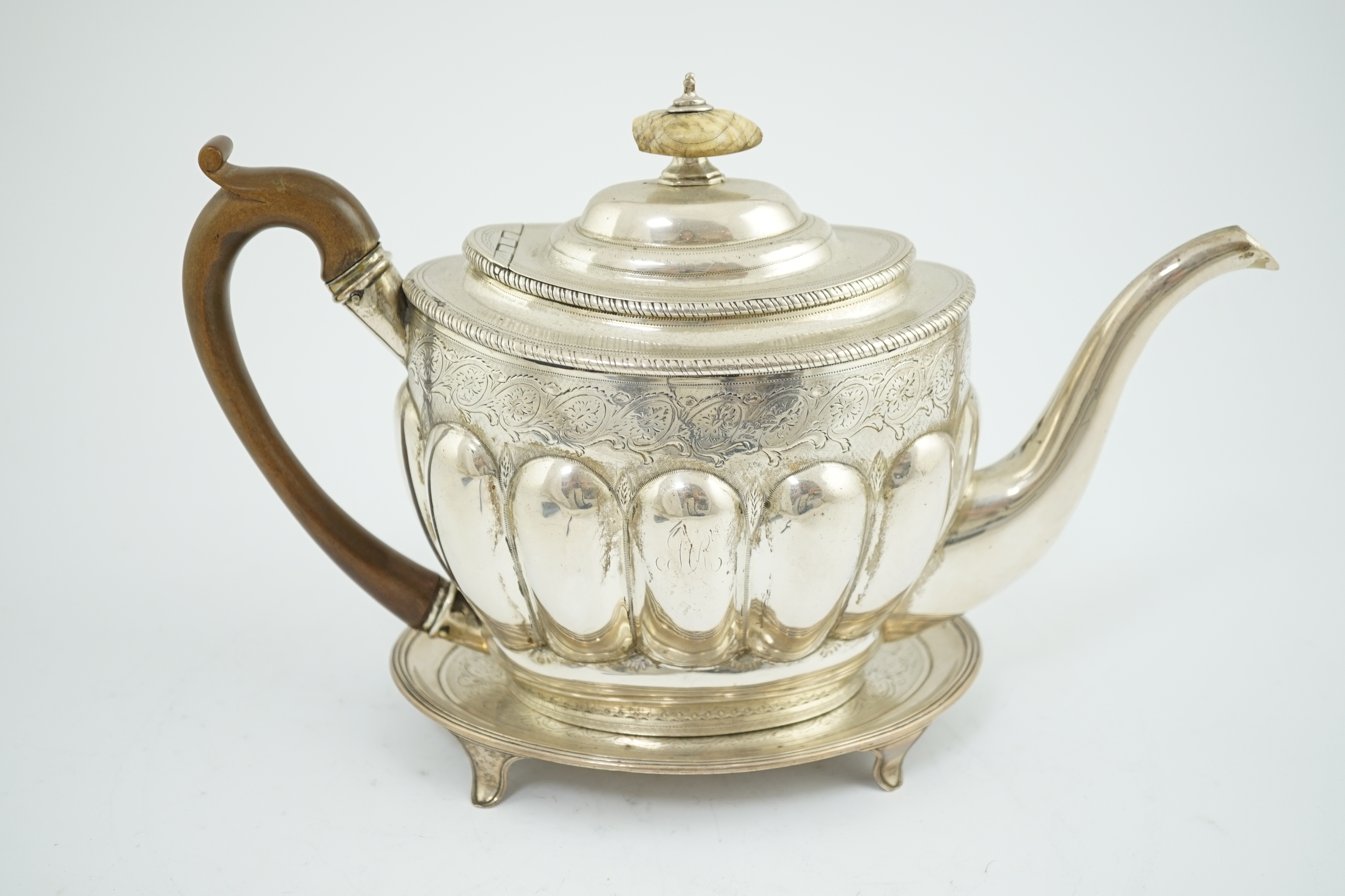 A George III engraved silver oval teapot by Soloman Hougham, together with a George III silver oval teapot stand, by John Eames, 16.8cm, CITES Submission reference YNZWLYTV